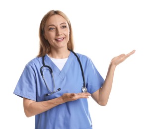 Doctor with stethoscope showing something on white background