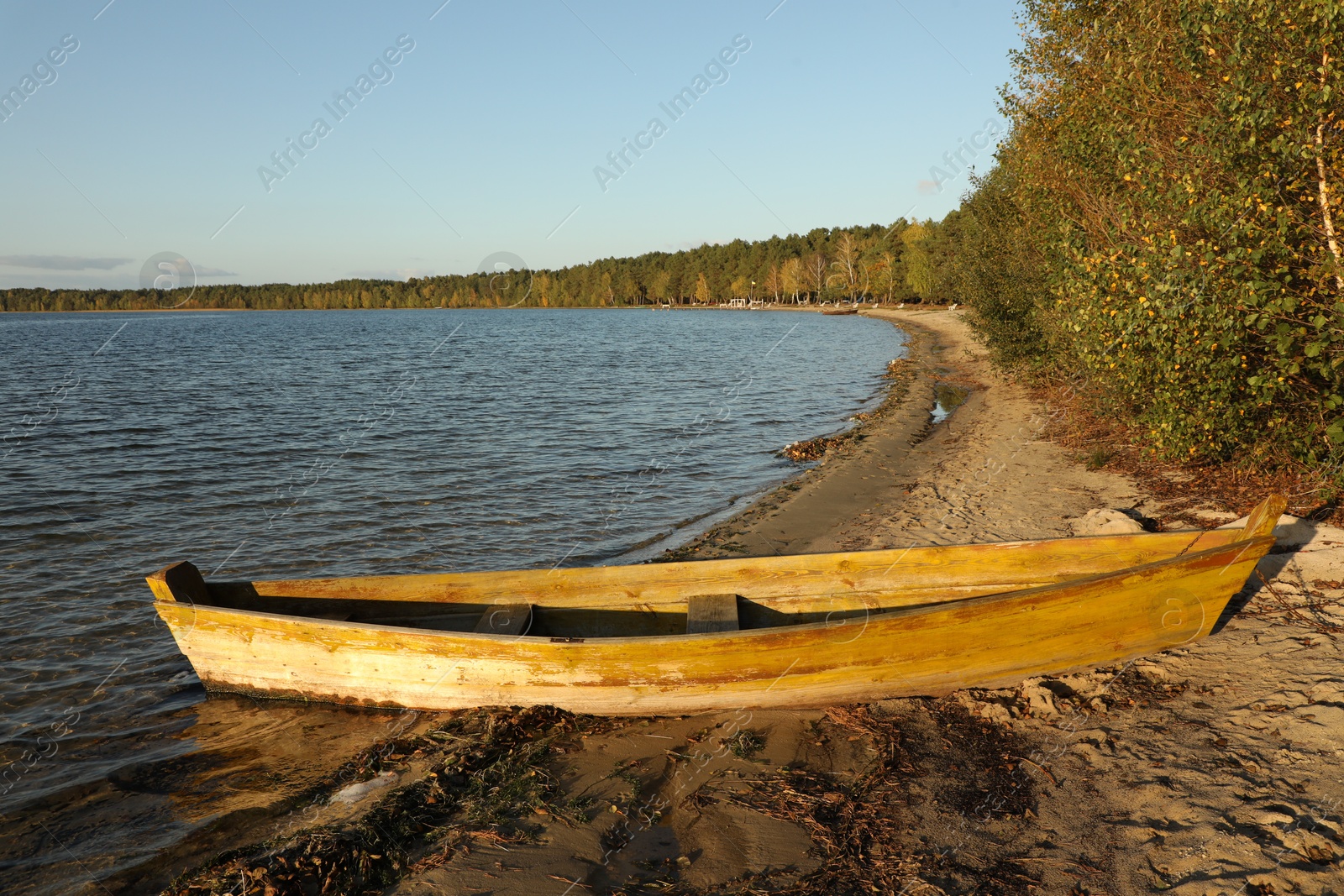 Photo of Wooden boat near river on sunny day