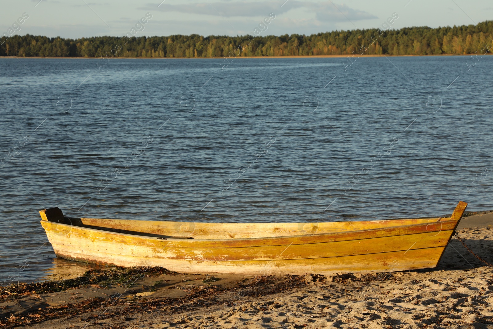 Photo of Wooden boat near river on sunny day