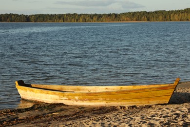 Wooden boat near river on sunny day