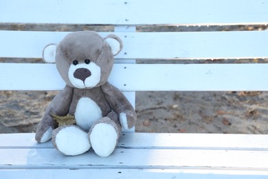 Photo of Lonely teddy bear on bench in park