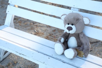 Photo of Lonely teddy bear on bench in park