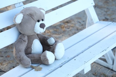 Photo of Lonely teddy bear on bench in park