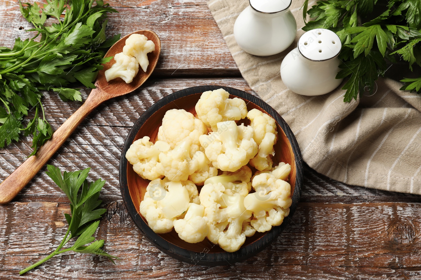 Photo of Tasty cauliflower served on wooden table, flat lay