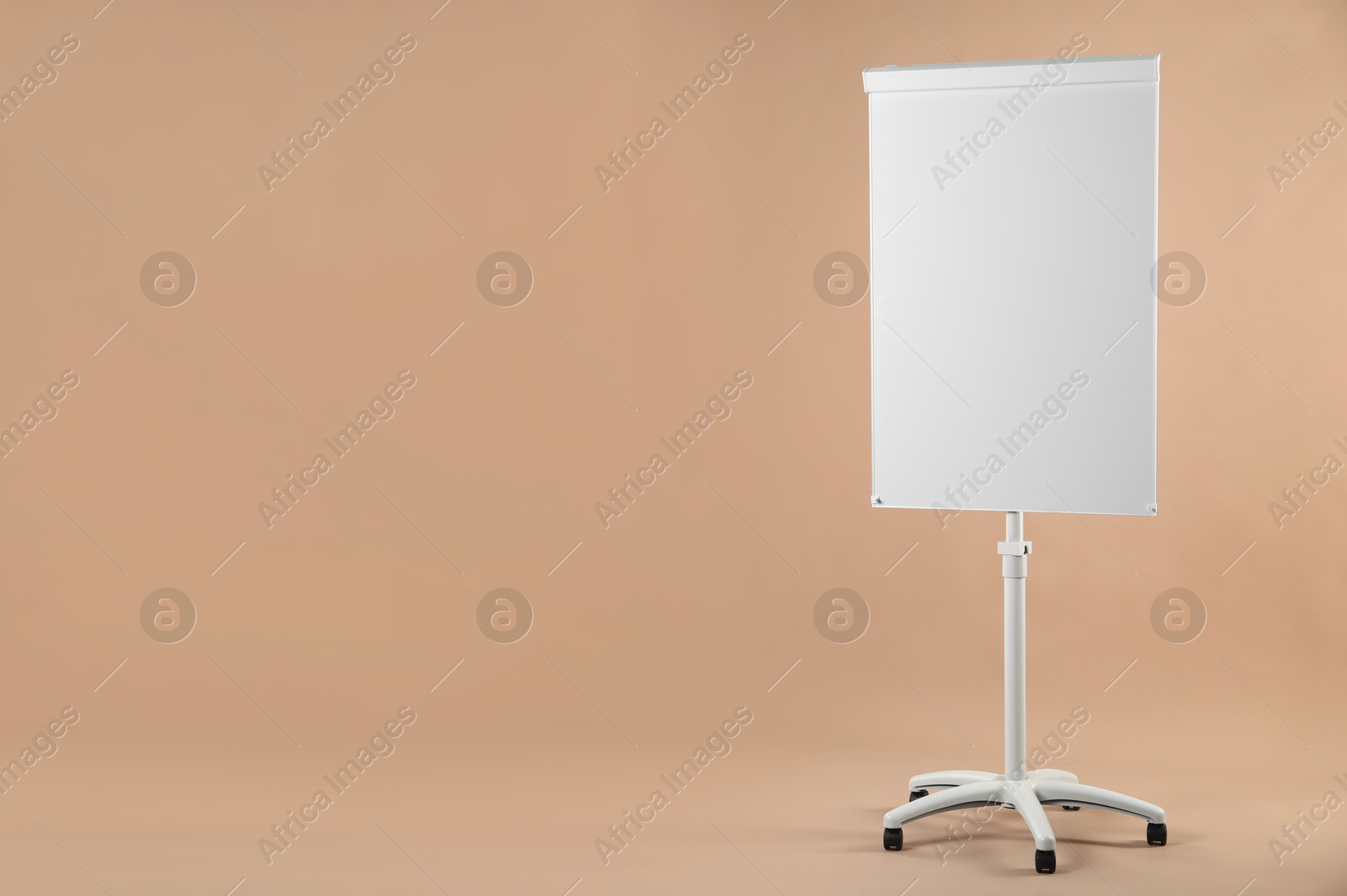 Photo of Flip chart on pale brown background. Mockup for design