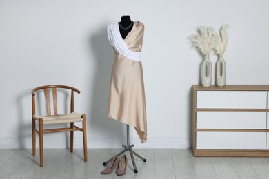 Photo of Female mannequin with draping and shoes in designer's workshop