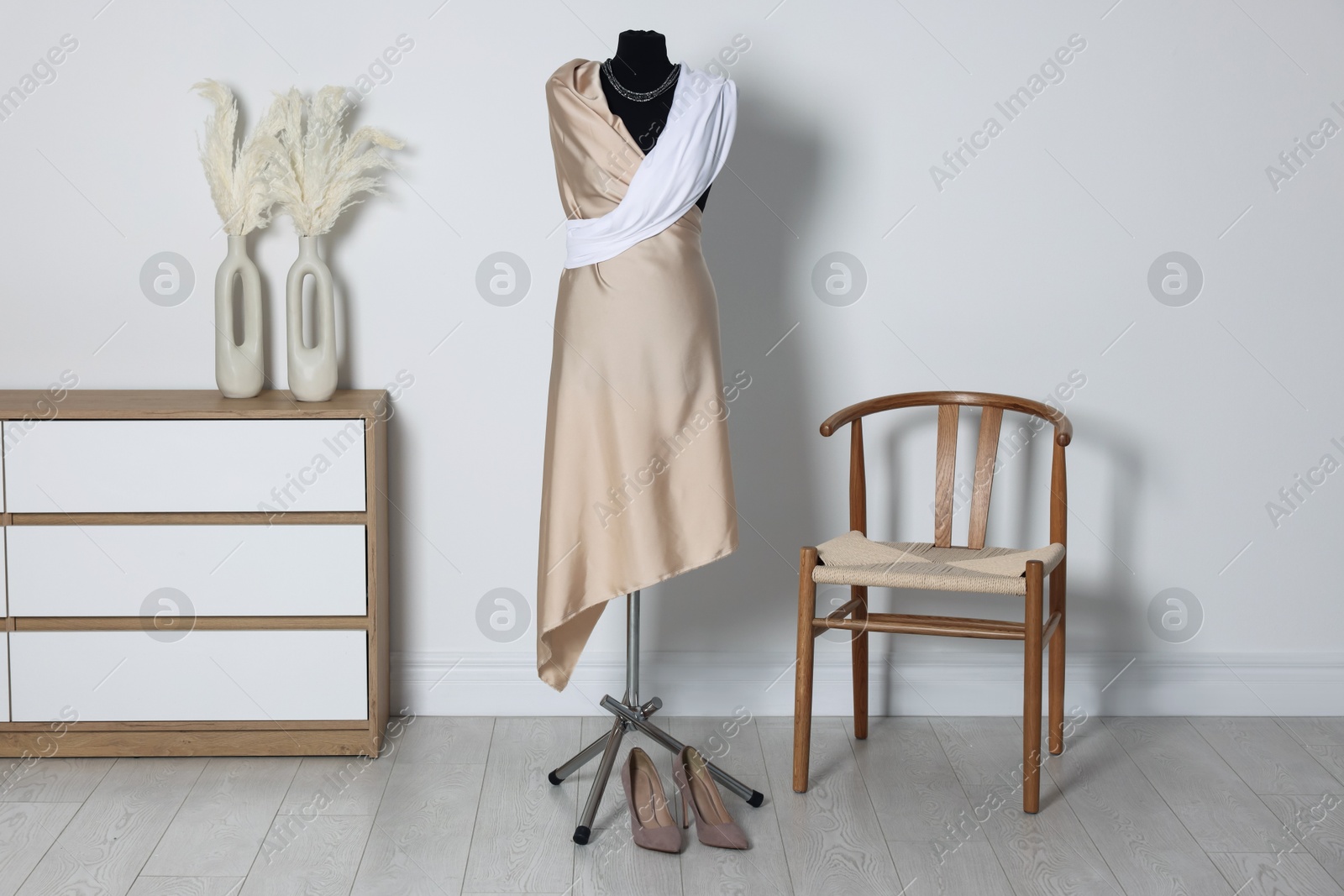 Photo of Female mannequin with draping and shoes in designer's workshop