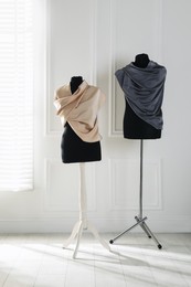 Photo of Female mannequins wrapped in fabric near light wall