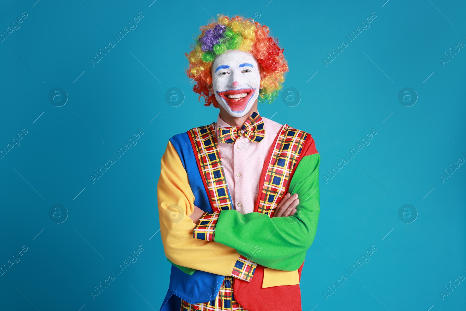 Photo of Portrait of happy clown on blue background