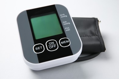 Photo of Blood pressure measuring device on white background, closeup