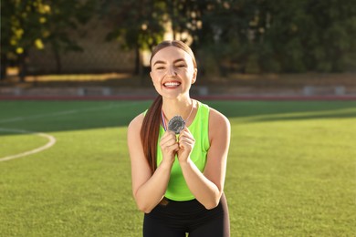 Happy winner with silver medal at stadium