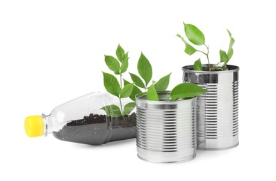 Photo of Recycling concept. Plastic bottle and cans with plants isolated on white