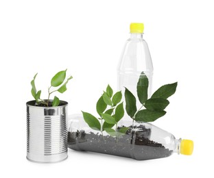 Photo of Recycling concept. Plastic bottles and can with plants isolated on white