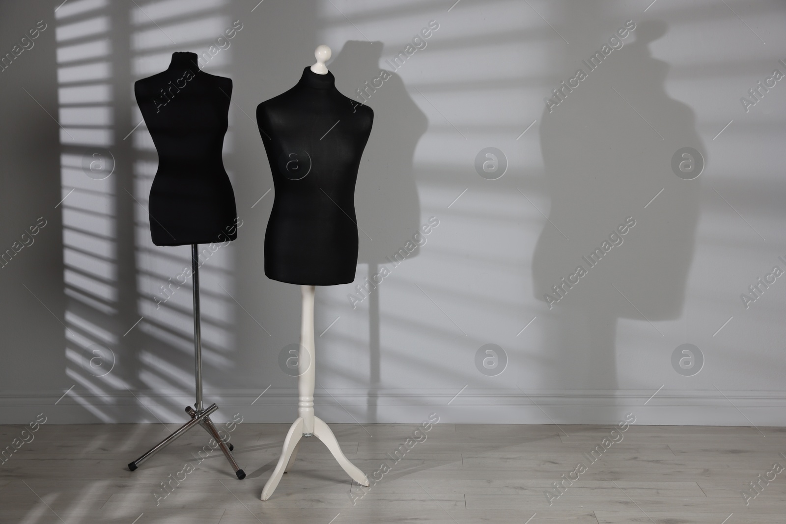 Photo of Black mannequins indoors, space for text. Fashion designer`s equipment