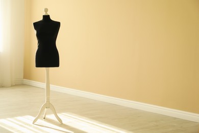 Photo of One black female mannequin indoors. Space for text