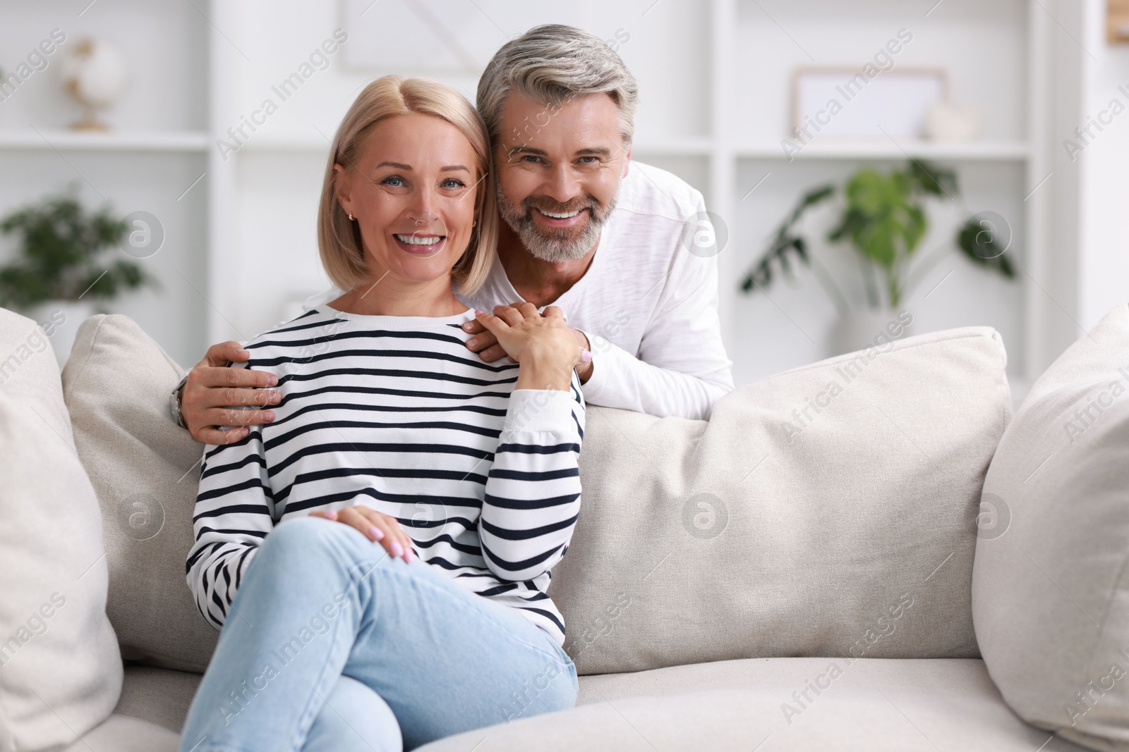 Photo of Portrait of happy middle aged couple at home