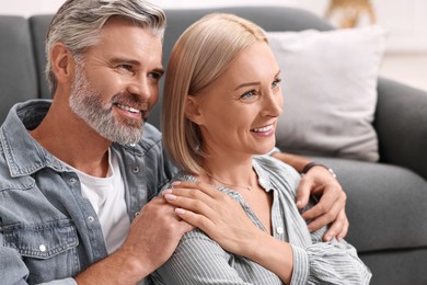 Portrait of happy middle aged couple indoors