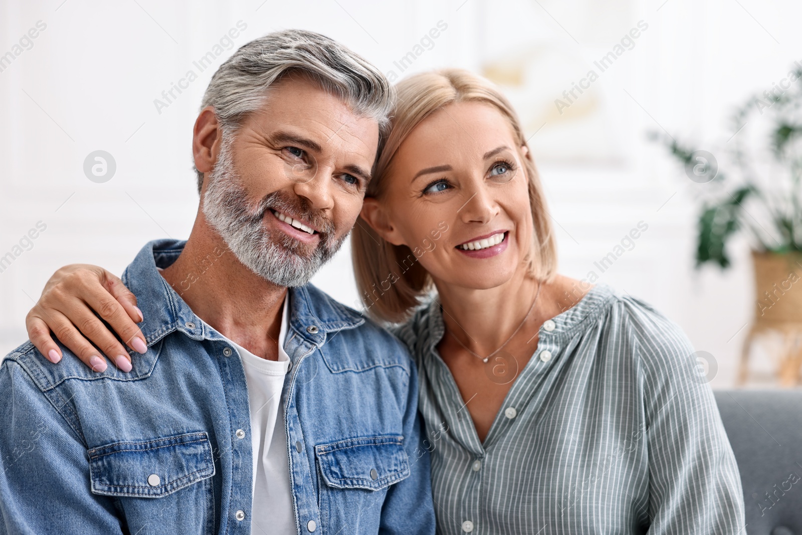 Photo of Portrait of happy middle aged couple at home