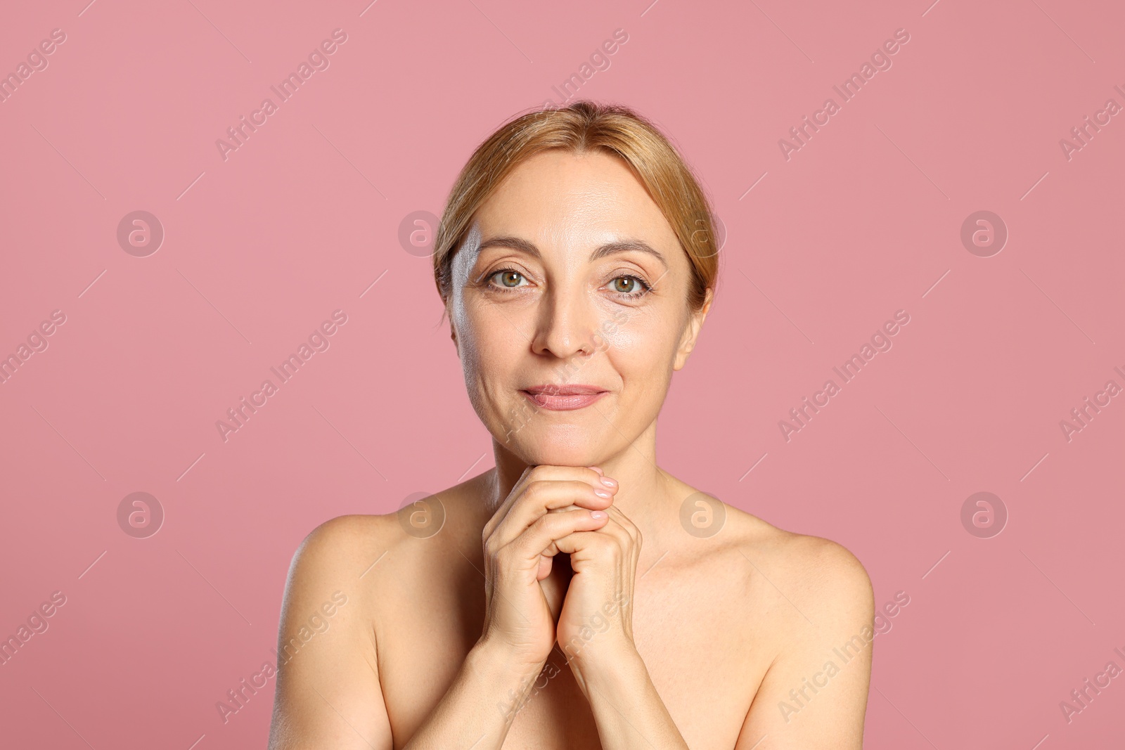 Photo of Portrait of beautiful woman with healthy skin on pink background