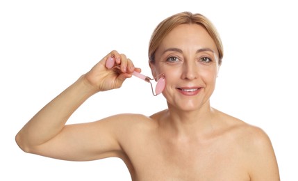 Photo of Smiling woman doing facial self massage with roller on white background