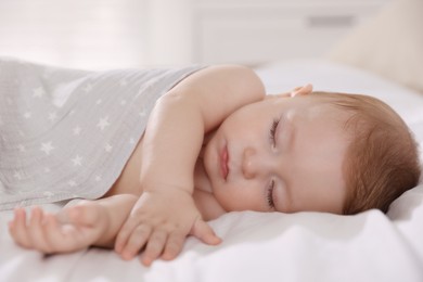 Cute little baby sleeping on bed at home