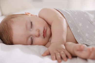 Cute little baby sleeping on bed at home