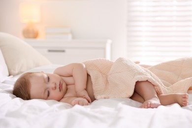 Cute little baby sleeping on bed at home