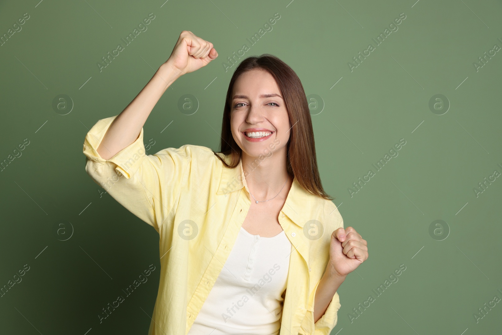 Photo of Portrait of happy winner on green background