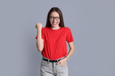 Portrait of happy winner on gray background