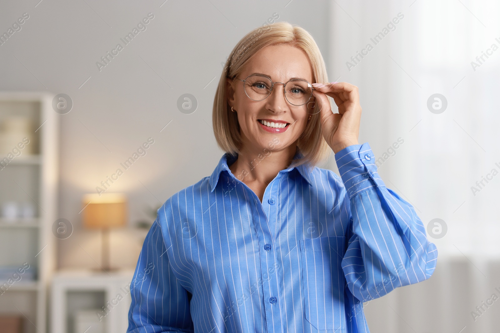 Photo of Portrait of smiling middle aged woman at home