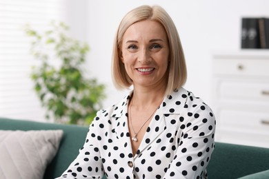 Photo of Portrait of smiling middle aged woman at home