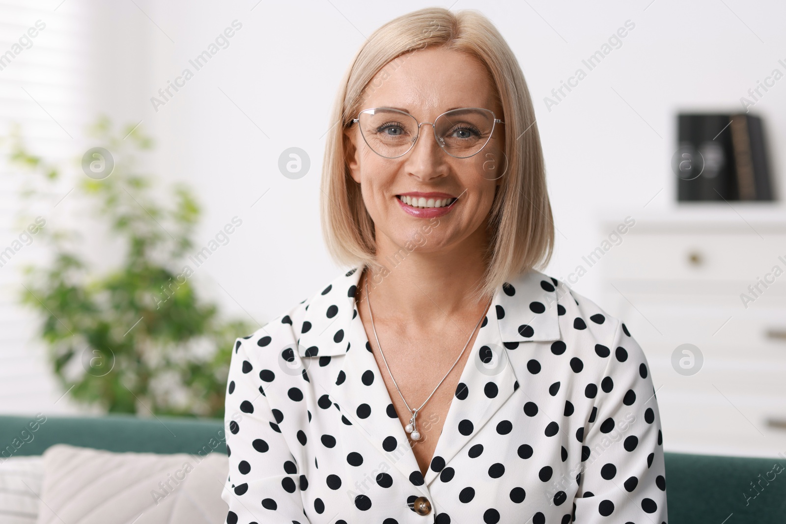 Photo of Portrait of smiling middle aged woman at home