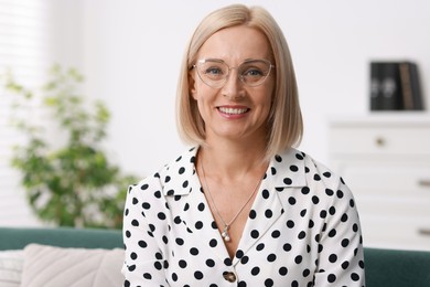 Portrait of smiling middle aged woman at home