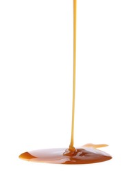 Photo of Tasty caramel sauce dripping on white background, closeup