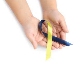 Photo of Child with yellow and blue ribbon on white background, top view. Down syndrome awareness