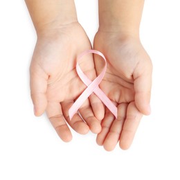 Photo of Child with pink ribbon on white background, top view. Breast cancer awareness