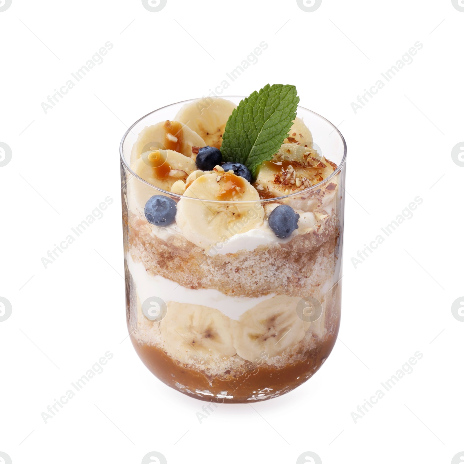 Photo of Tasty trifle dessert. Sponge cake, blueberries, banana and whipped cream in glass isolated on white