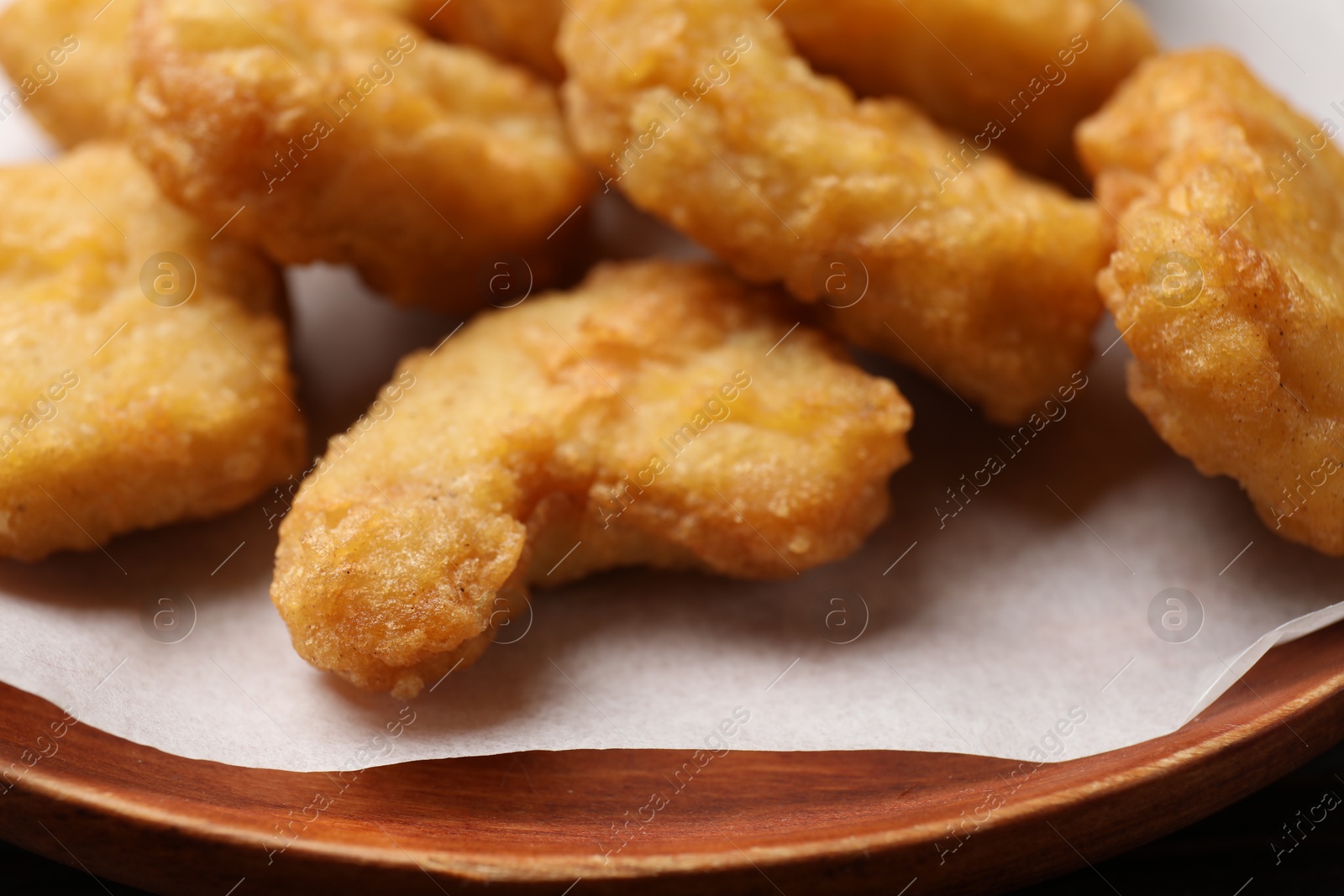 Photo of Delicious fresh chicken nuggets on plate, closeup