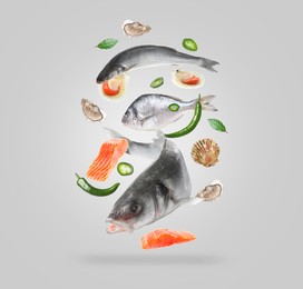 Image of Different sea food in air on light grey background