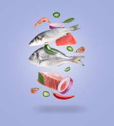 Image of Different sea food in air on violet blue background