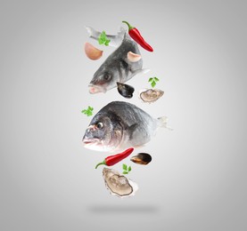 Image of Different sea food in air on light grey background