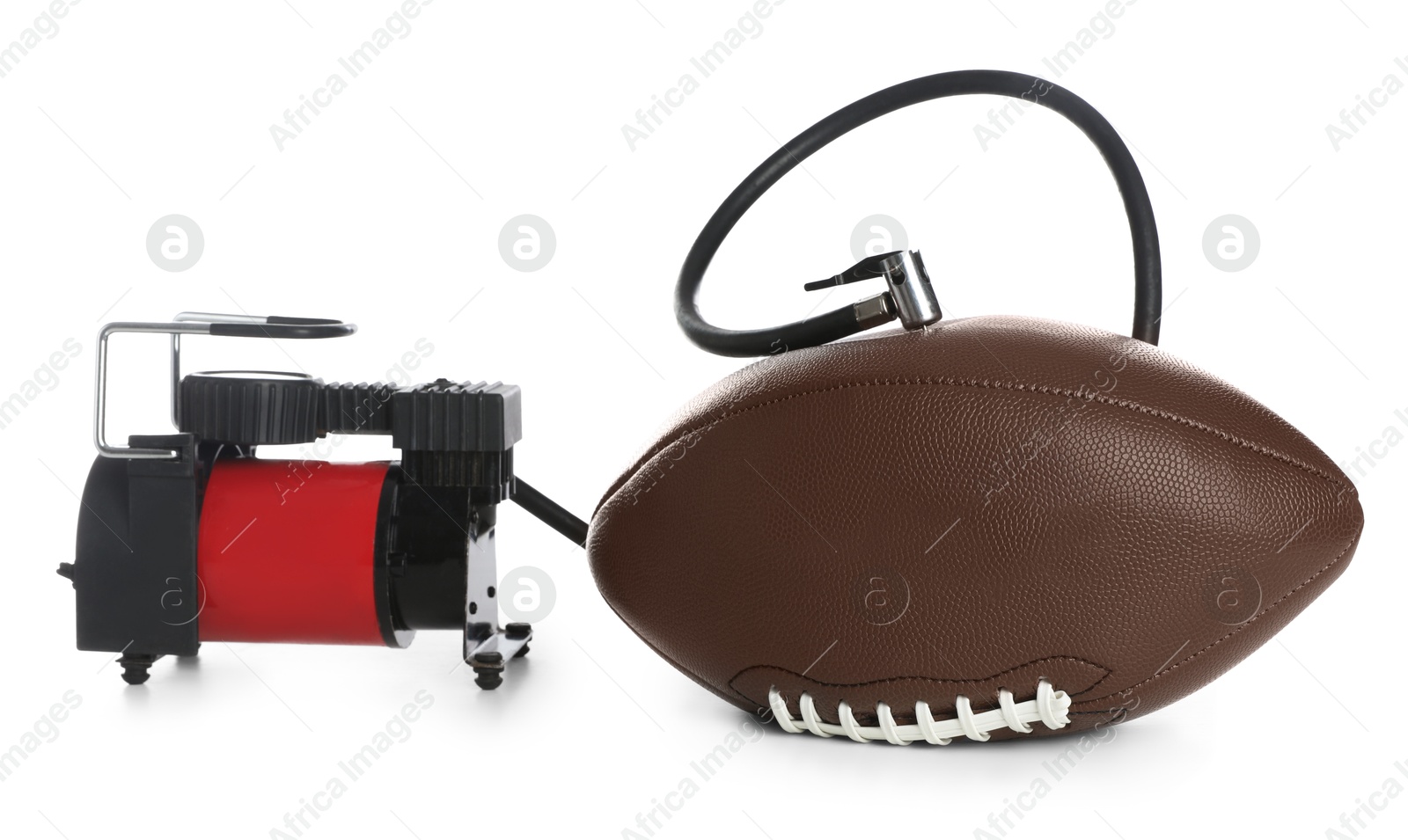 Photo of American football ball and air compressor isolated on white