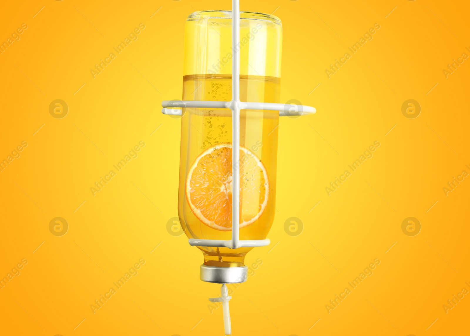 Image of Vitamin intravenous therapy. IV infusion set on orange background. Glass bottle with orange slice inside