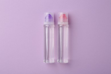 Transparent glue on violet background, flat lay