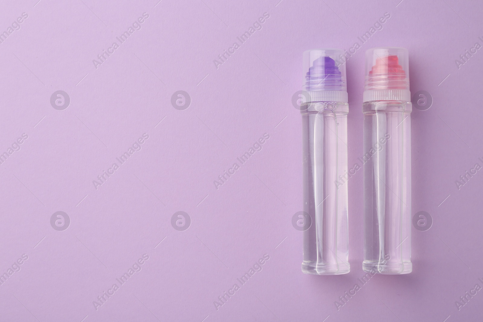 Photo of Transparent glue on violet background, flat lay. Space for text