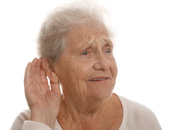 Photo of Senior woman showing hand to ear gesture on white background