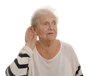 Senior woman showing hand to ear gesture on white background