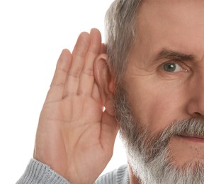 Photo of Senior man showing hand to ear gesture on white background, closeup