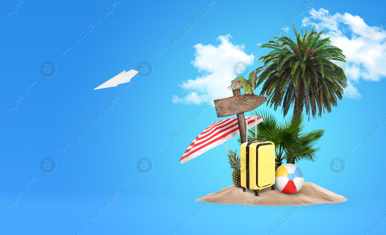 Image of Summer travel. Pile of sand with palms, suitcase, wooden direction sign, beach ball and umbrella under clouds on light blue background, space for text. Paper plane flying over island