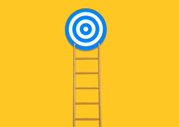 Image of Ladder leading to target on golden background. Concepts of success and goal achievement